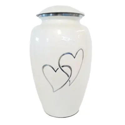 Tibor de aluminio blanco con corazones de Urnas Sacbe, una delicada y significativa urna funeraria. Su diseño único combina pureza y amor, ofreciendo un homenaje conmovedor y respetuoso.
